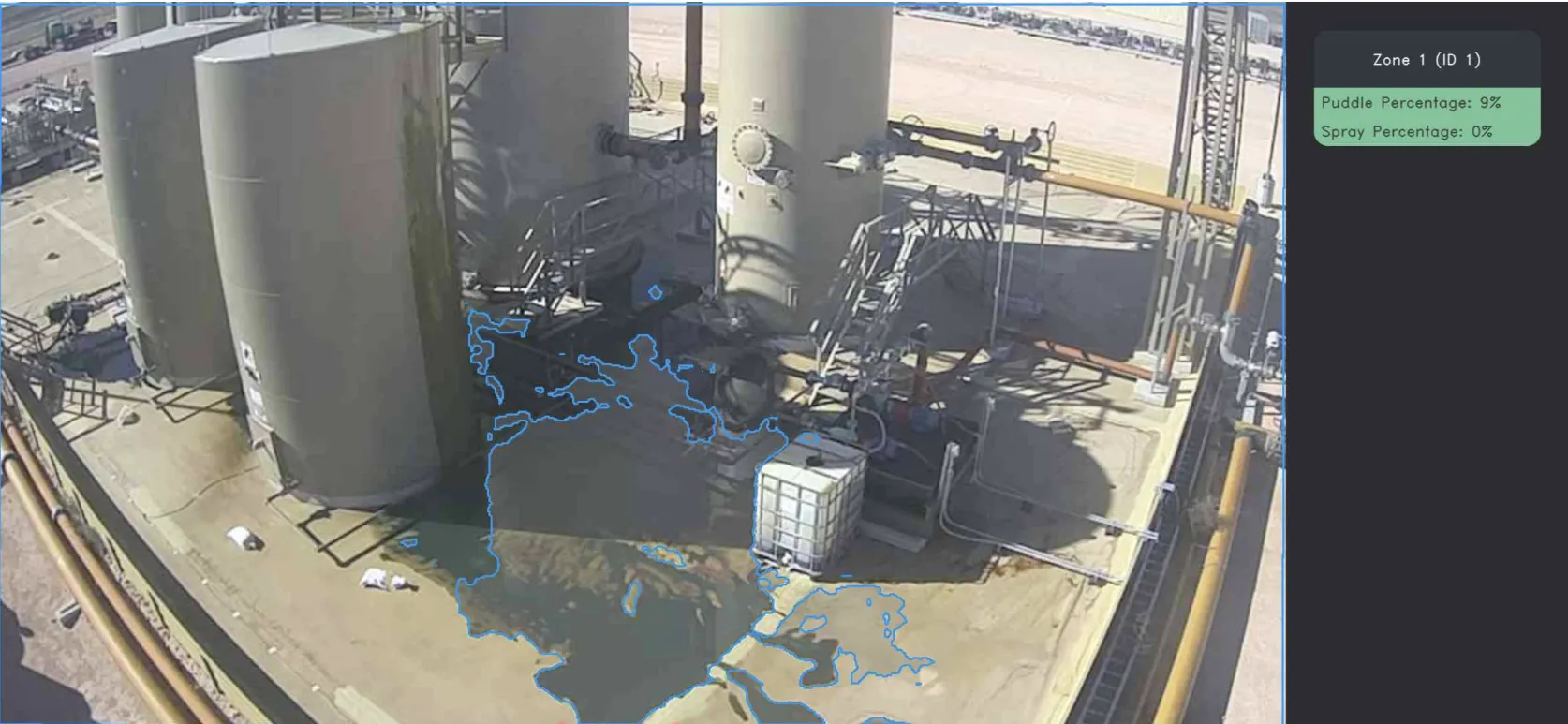 Tank battery — blue-outlined puddle