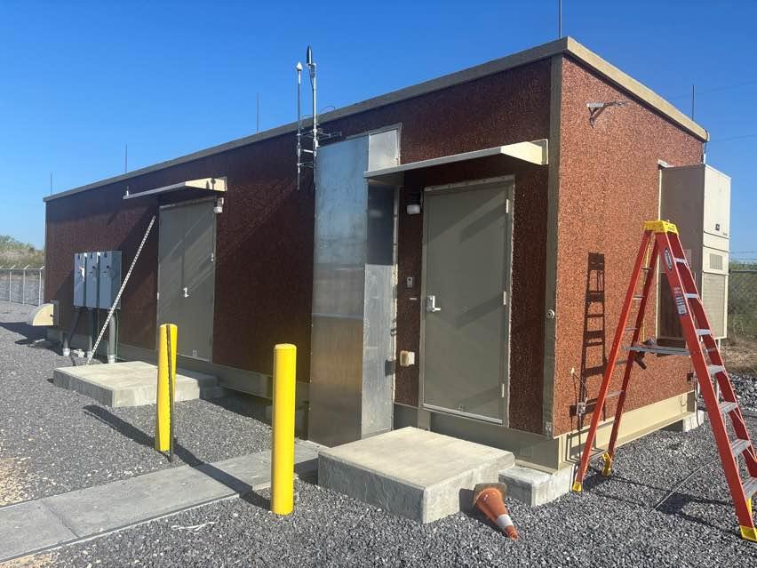 Reinforced substation control building at a utility-scale solar power plant — concrete and metal construction that attenuates RF signals from the macro cellular network